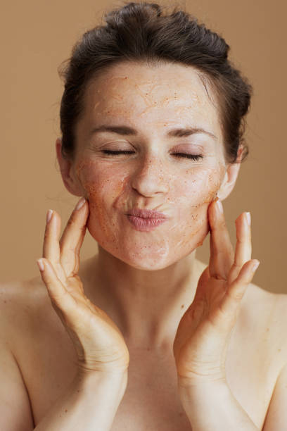 istock young 40 years old woman with face scrub 1443301691