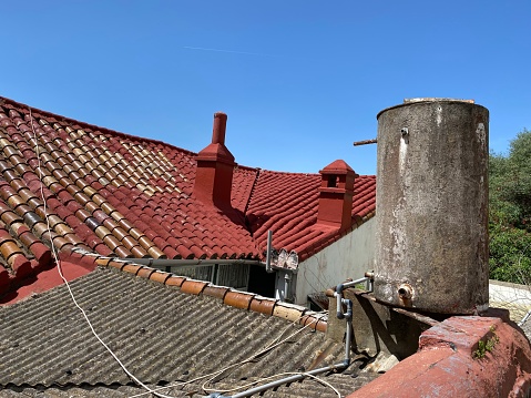 Asbestos cement water tank on the roof of a house