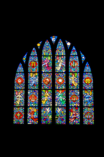 Sunlight pouring through stained glass windows of a church in Kaysersberg France