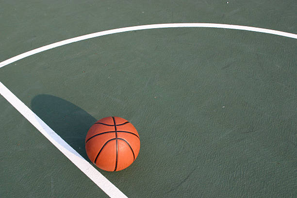 istock Basketball on Green Court 144330578