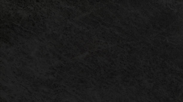 istock dark black wall texture, background. rough clean concrete wall in close-up view with blank space for design. rough marble texture background, black tiles marbel stone surface. 1443308660
