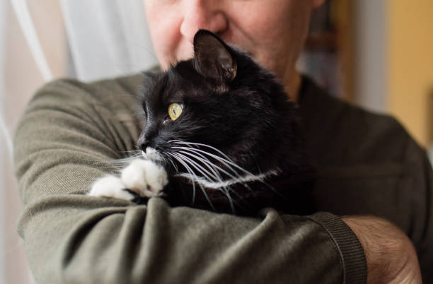 Young man carrying his cat.