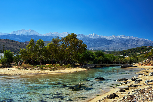 River mouth and view of the Lefka Ori mountains in the town of Georgioupoli on the island of Crete, Greece