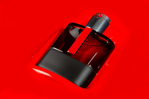 A bottle of after shave in sank in red paint