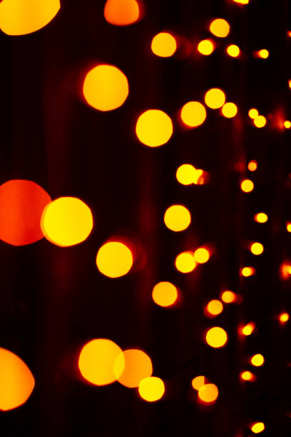 istock Gold and red blurred light bokeh on black background 1443311407