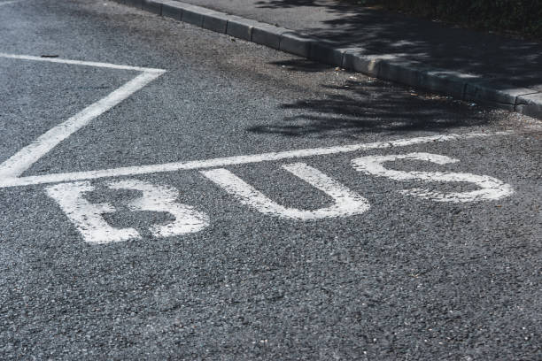 istock Bus road mark on black asphalt next to sidewalk 1443312809
