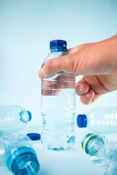 istock Hand taking water bottle and some other plastic bottles 1443316634