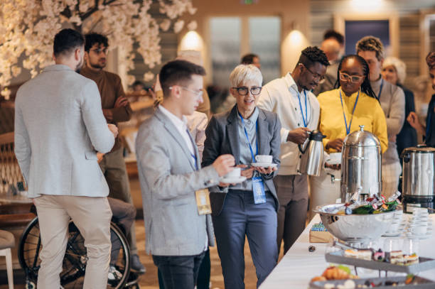 Business people at banquet Diverse group of people, business people  taking a break  to have a snack at the convention center banquet. buffet hotel people women stock pictures, royalty-free photos & images