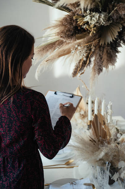 An Anonymous Woman Hosting A Christmas Dinner Party At Home