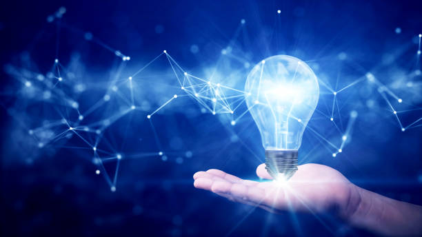 istock business idea creative concept technology. Illuminated light bulb and connected polygons above hand on dark blue background. 1443318145