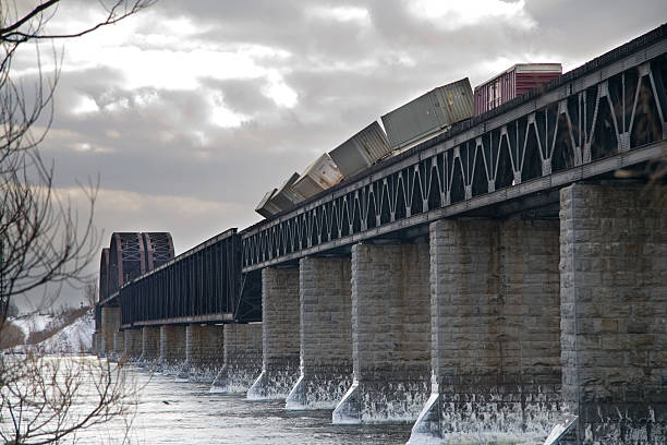 Derailed Train The high winds of 17 February 2006 have pushed this freight train off off of its tracks while it was crossing a bridge over the St-Laurence River on its way Montreal. derail stock pictures, royalty-free photos & images