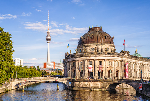Berlin, Germany - A view across the water of the River Spree to the Bode Museum, on Museum Island in central Berlin, with the TV Tower on the horizon.
