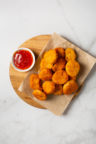 istock Top view of nuggets and red dip light surface fast food 1443319082