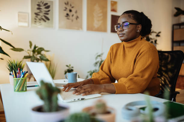 istock Female African entrepreneur working from green office and using laptop for remote work 1443320900