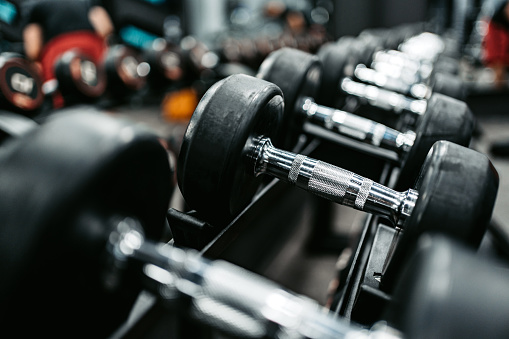 Close-up of different sized dumbbells at the gym.