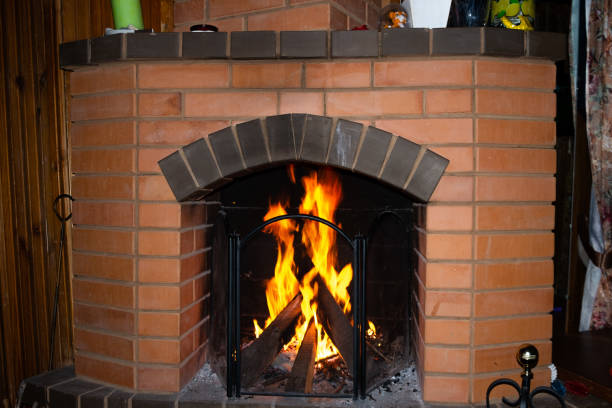 istock A brick fireplace in which a fire burns in country cottage. 1443322948