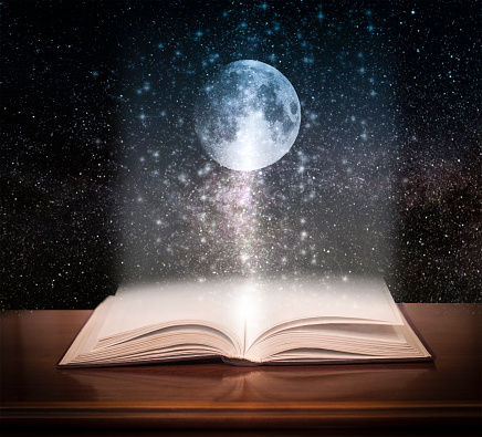 Open book with space and moon. Fairy tale concept.
