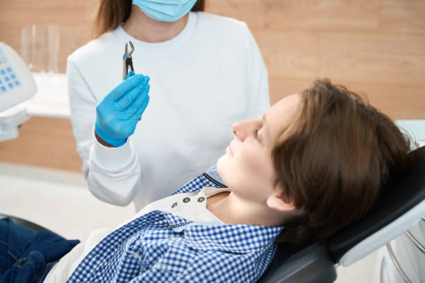 istock Boy looks at a special tool for tooth extraction 1443325057