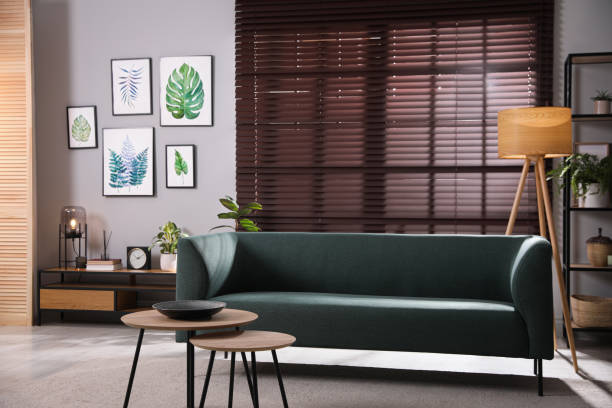 istock Stylish living room interior with comfortable sofa and small tables 1443327047