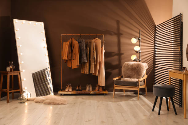 istock Stylish mirror with light bulbs and comfortable armchair in dressing room. Interior design 1443327129
