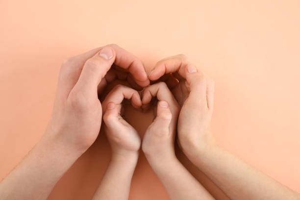 istock Happy family holding hands on beige background, top view 1443327399