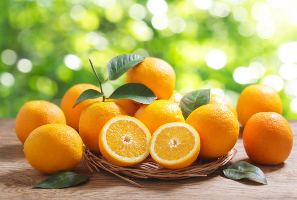 istock fresh orange fruits with leaves 1443328366