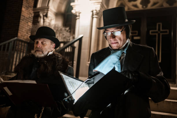 Two handsome 1920s style gentlemen wearing white tie and top hat on a luxury stately home staircase