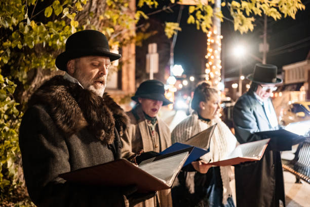 istock Mature people singing Christmas carols outdoors at night 1443328499