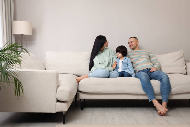 istock Happy family spending time together on sofa at home 1443328800