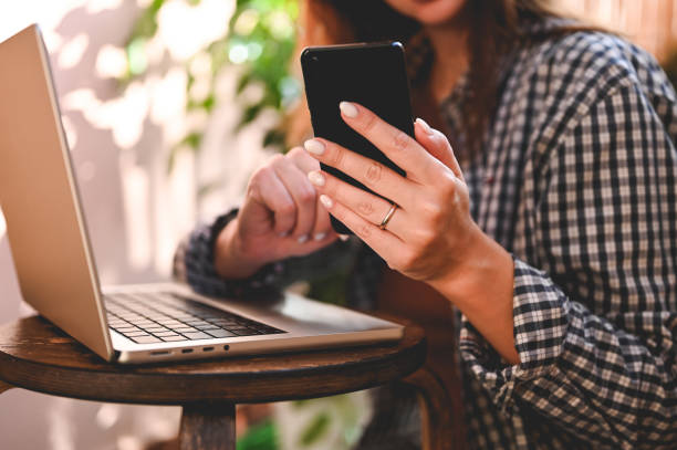 istock female hands typing text message via cellphone 1443329070