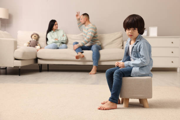 couple arguing at home, focus on their upset child - domestic life young family family child imagens e fotografias de stock