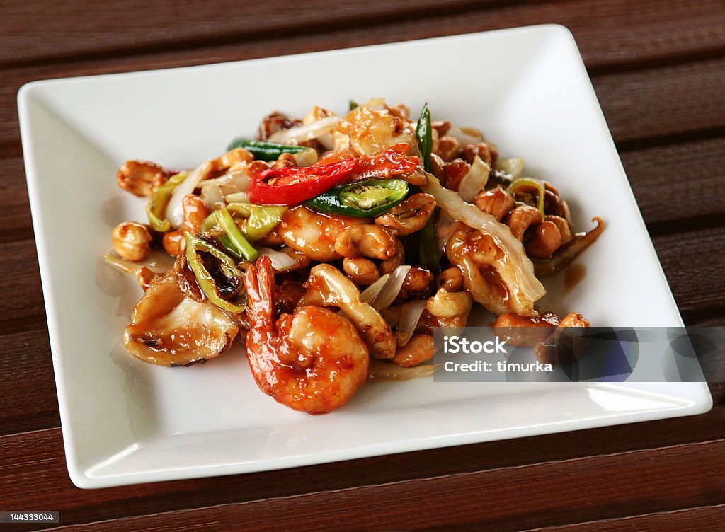 Shrimps with cashew nuts and chili pepper Shrimps with cashew nuts AA celery, bamboo shoots, cashew nuts and chili pepper stir fried in dark tangy sauce. Thai food is very delicious! The image with path. Backgrounds Stock Photo
