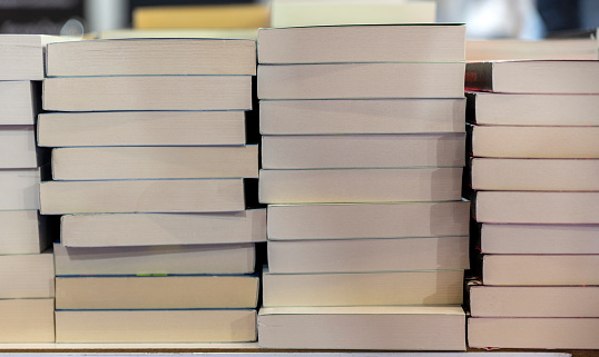 lots of books stacked on top of each other