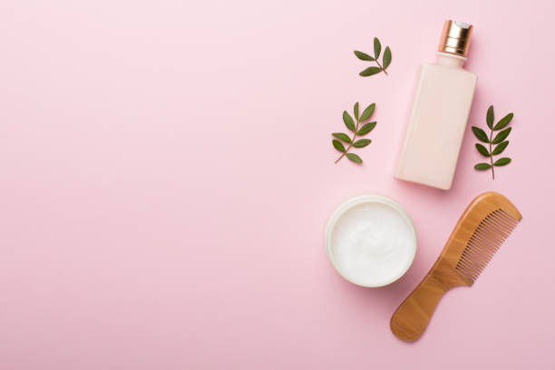 istock Shampoo and conditioner with herbal extract and comb on color background, top view 1443331874
