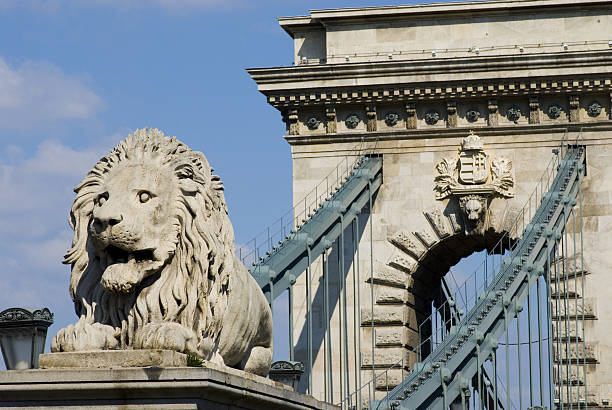 istock View of stone arch and chain bridge with lion statue 144333395