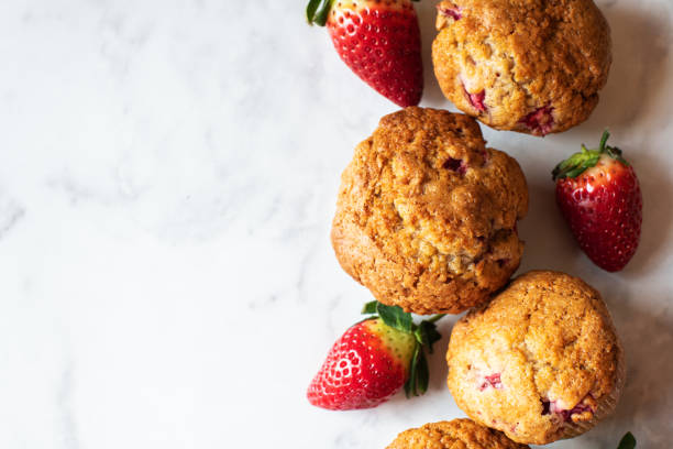 istock Strawberry muffins on a white marble background. Top view and copy space. 1443334080