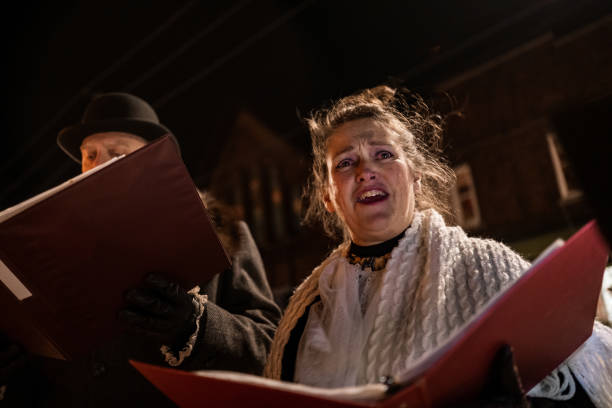 istock Mature people singing Christmas carols outdoors at night 1443334464