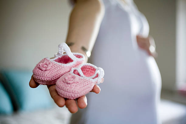 Booties Pregnant Woman Holding Booties water birth photos stock pictures, royalty-free photos & images