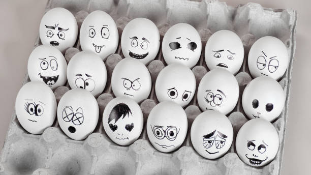 istock Many eggs with funny faces on cardboard palette 1443339438