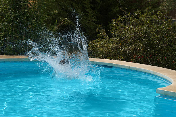 istock child jumping into the water 144334071