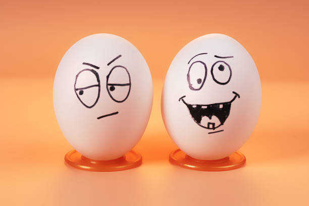 Two eggs with worried and carefree faces
