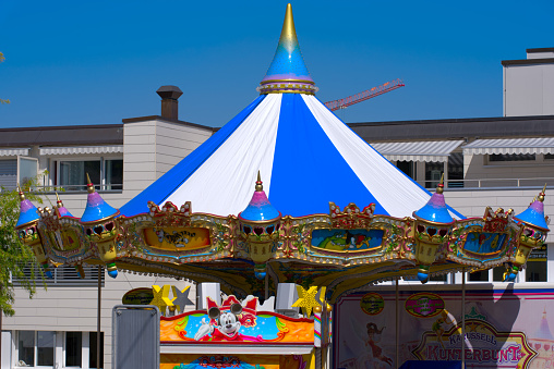 Merry go round with decorations and Mickey Mouse at carnival at City of Zürich on a sunny late summer day. Photo taken September 2nd, 2022, Zurich, Switzerland.