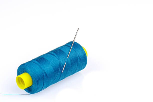 istock Macro skein of blue thread with a needle on a white background 1443341423