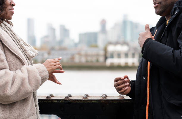 istock Portrait of unrecognizable couple using sign language to talk. 1443344035