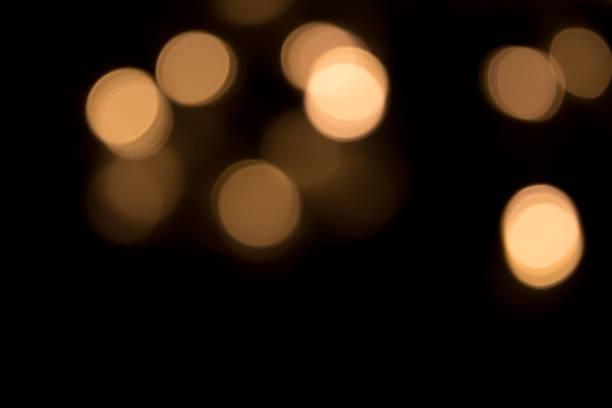 istock Golden bokeh light isolated on black background 1443344518