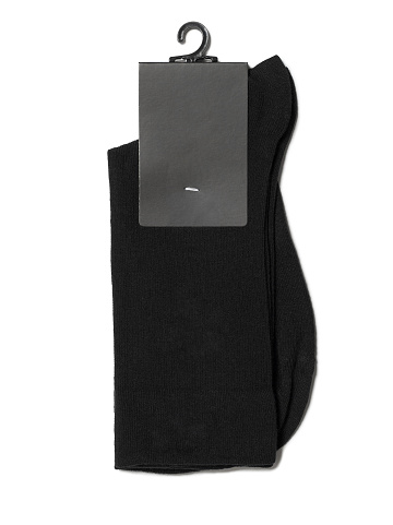 New black socks on a white background with a clean black tag for your design. Black Socks Mock-up with a blank label. High resolution photo. Isolated object. Top view.