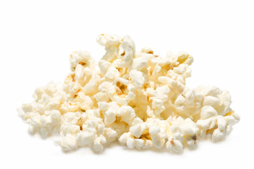 A pile of salted popcorn isolated on white background.