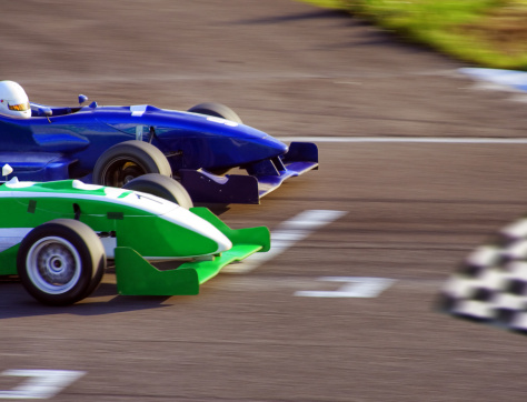Two formula cars speeding to finish line