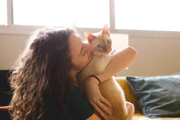 istock woman interacts with her pet cat 1443345588