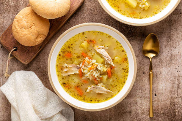 Top view of homemade rice and chicken soup in a bowl. stock photo